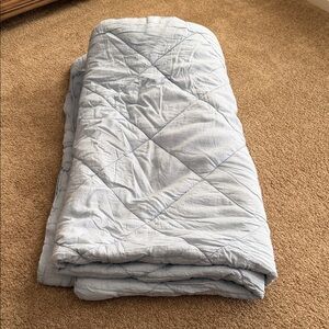 Pottery Barn quilted comforter in sky blue. Adds a cozy touch to your bedroom.